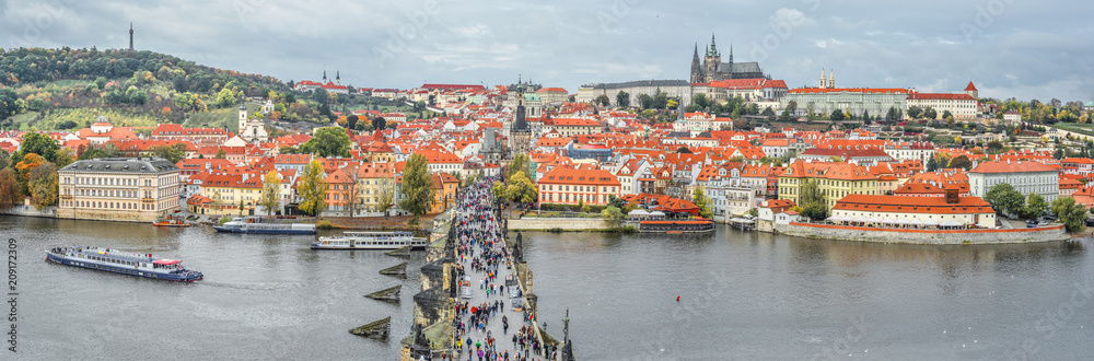 Obraz premium Prague, Czech Republic - October 8, 2017: Top view panorama of ancient Charles Bridge crosses Vltava river in Prague. Tourists are walking Charles Bridge Prague, Czech Republic. Panorama.
