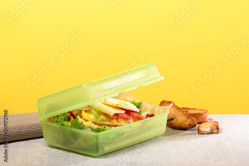 Sandwich in the food box on the yellow background. Healthy eating, lunch box promotion concept © Jurga Jot
