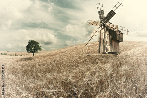 Vintage Windmill on Wheat Field