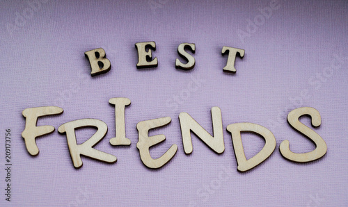 Message best friends of wooden blocks on a purple color background.