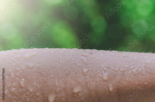 Human skin with water drop and water spread, Droplet of water on skin.