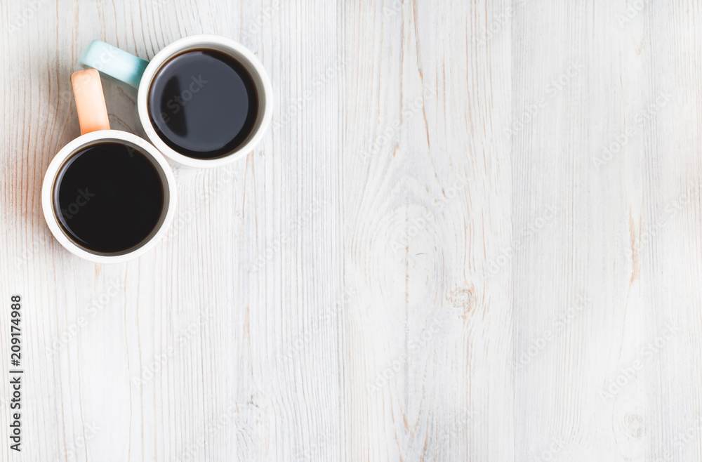 Two cups of coffee on white wooden table. Top view, flat lay. Two cups of coffee on white wooden table. Top view, flat lay.