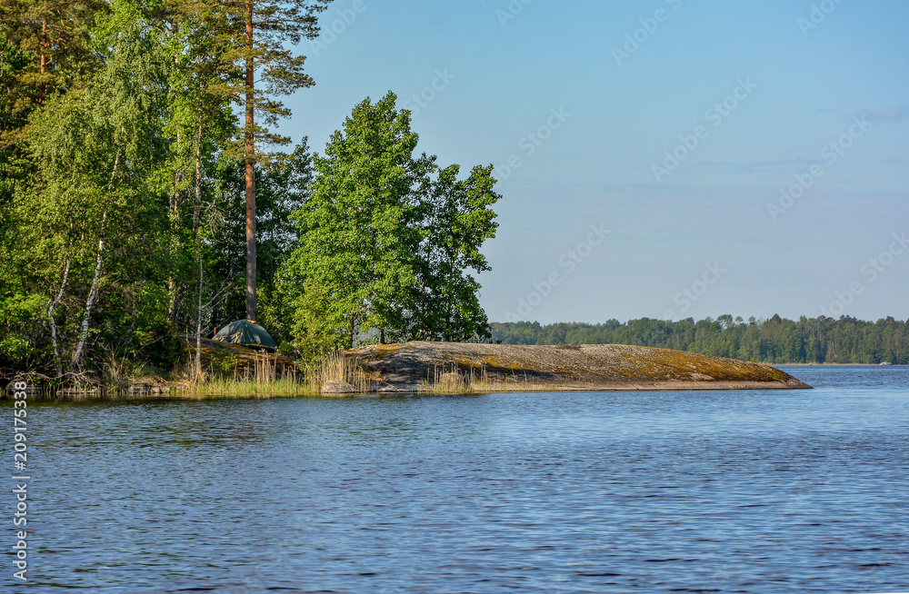 Islands in the North of the Leningrad region on lake Vuoksa. Sunny morning on the water. Islands in the North of the Leningrad region on lake Vuoksa. Sunny morning on the water.