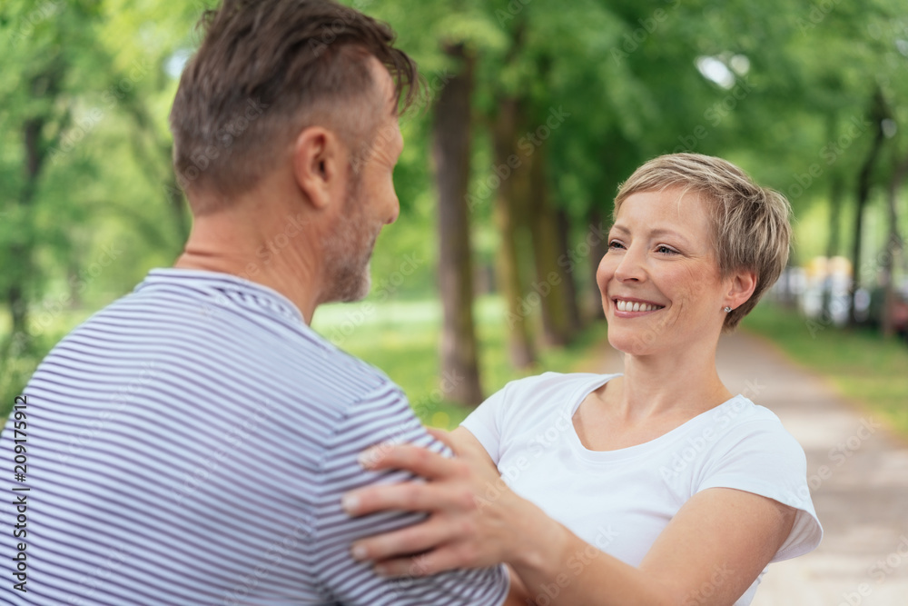 Obraz premium Happy attractive woman hugging her husband