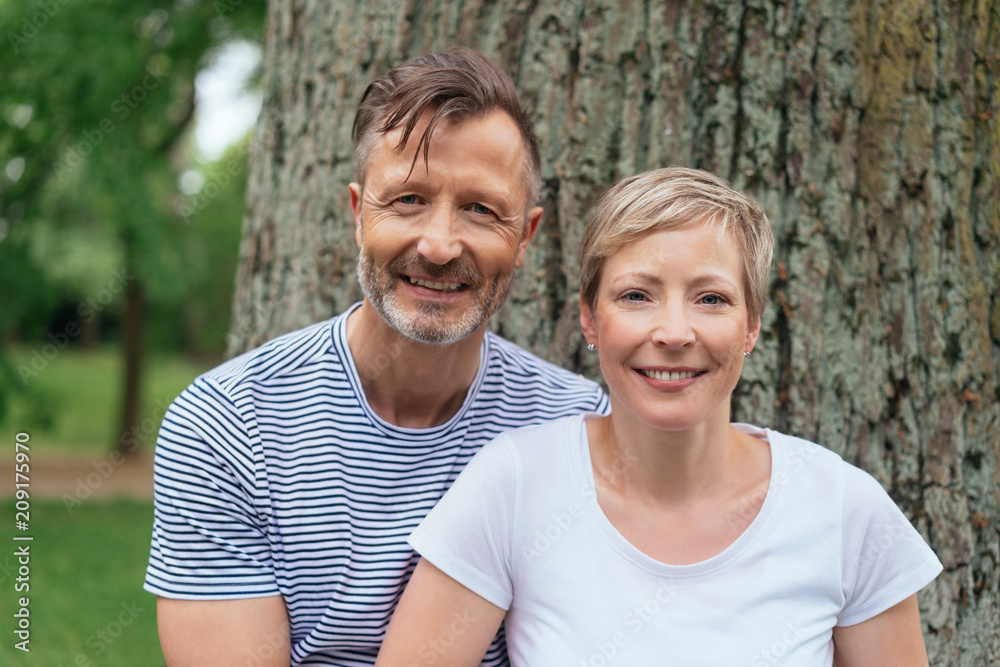 Portrait of a happy middle-age couple in the park
