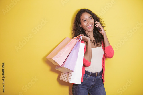 asian woman with shopping bag talking on a mobile phone