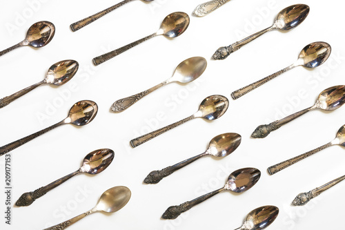 Vintage spoons, silverware pattern on white background. Kitchen texture. Top view.