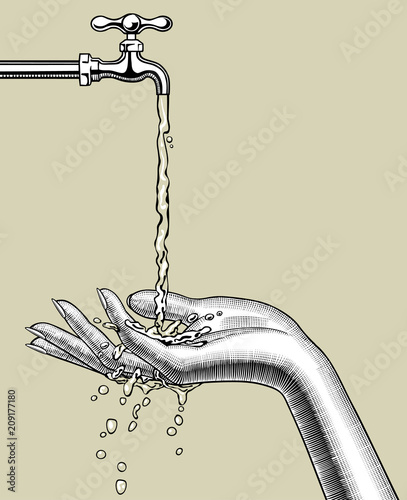 Female palm up under a stream of water running down from a tap