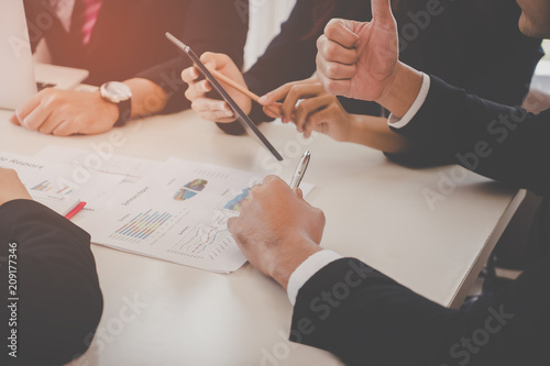 Business team is seriously discussing in meeting, no face