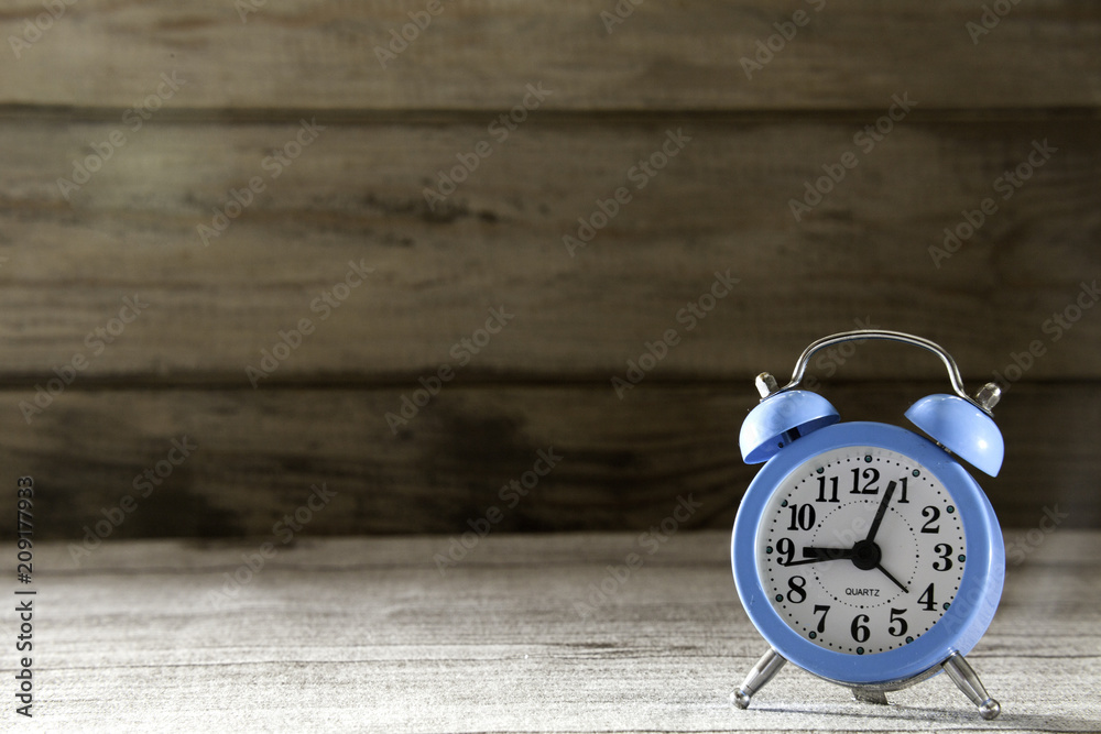blue alarm clock on wood background blue alarm clock on wood background