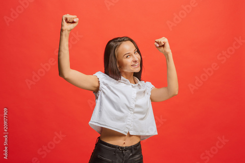 Winning success woman happy ecstatic celebrating being a winner. Dynamic energetic image of female model