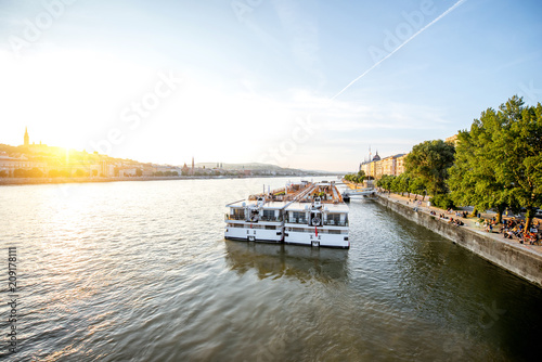 Landscape view on Danube river with tourist ship during the sunset in Budapest city, Hungary