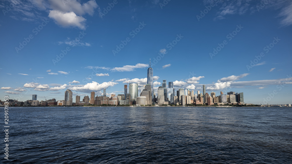 New york city skyline daytime sun clouds blue