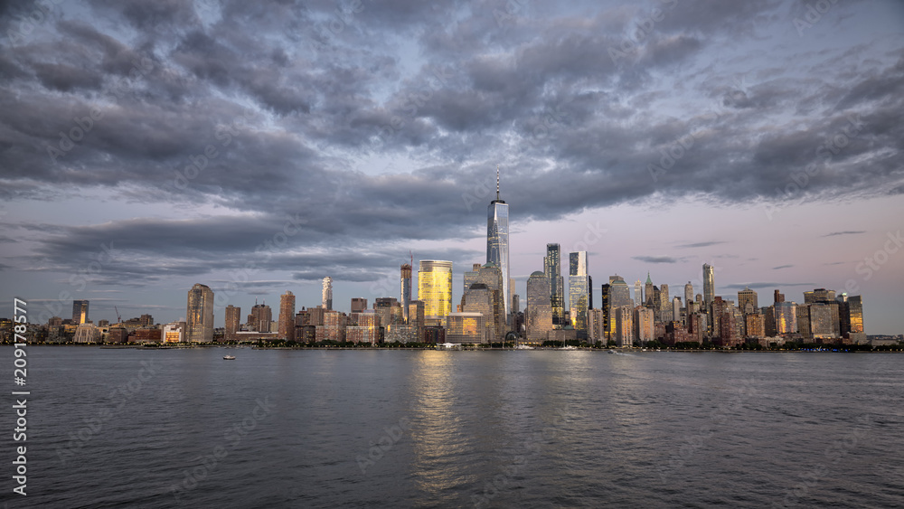New york city skyline daytime sun clouds blue golden hour