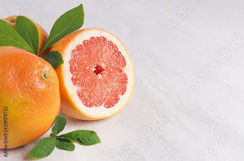 Juicy fresh round slice pink grapefruit macro wiht green leaf, copy space.