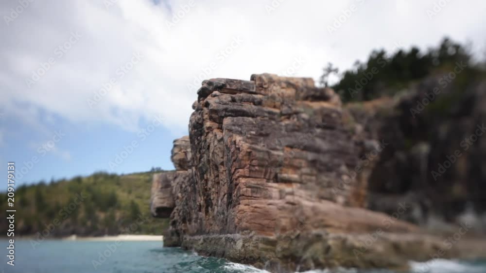 A wide shot passing by rock formations. The rocks are old and colored brown. A wide shot passing by rock formations. The rocks are old and colored brown.