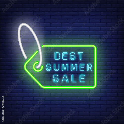 Best summer sale neon sign. Green tag with string on dark blue brick wall. Night bright advertisement. Vector illustration in neon style for shopping and consumerism