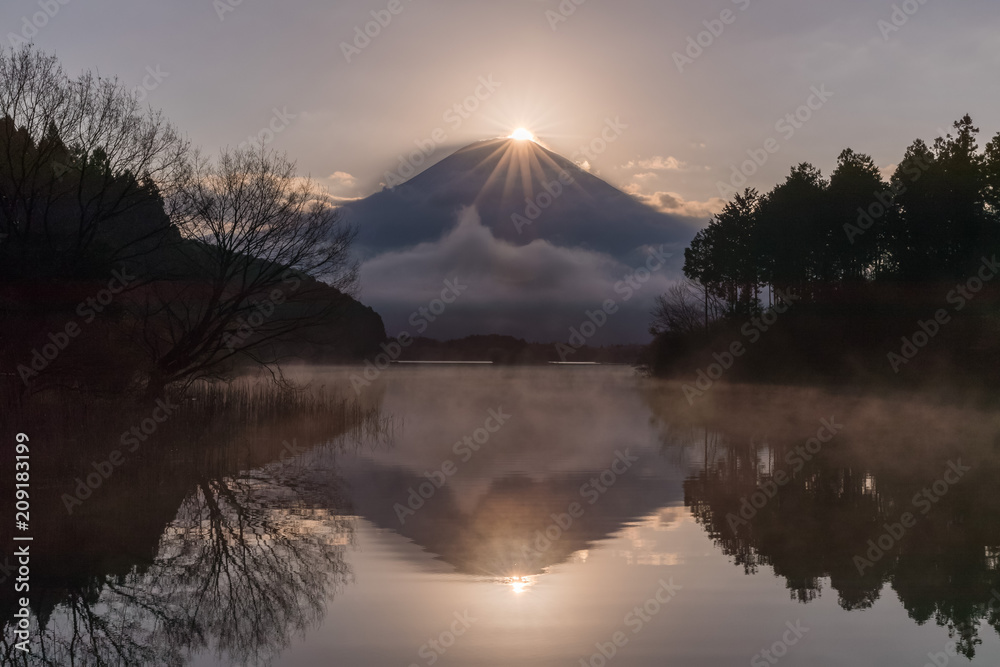 Diamond Fuji at Tanuki lake in morning spring season. Diamond Fuji is the name given to the view of the setting sun meeting the summit of Mt. Fuji.
