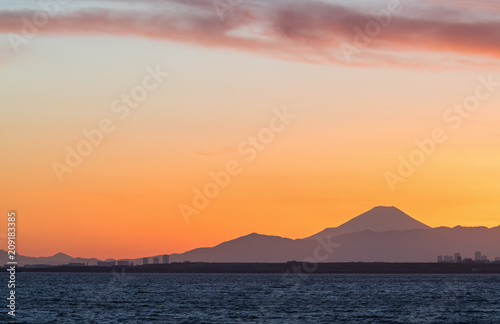 Mountain Fuji and Tokyo bay at sunset time in winter season.Tokyo Bay is a bay located in the southern Kanto region of Japan  and spans the coasts of Tokyo  Kanagawa Prefecture  and Chiba Prefecture.