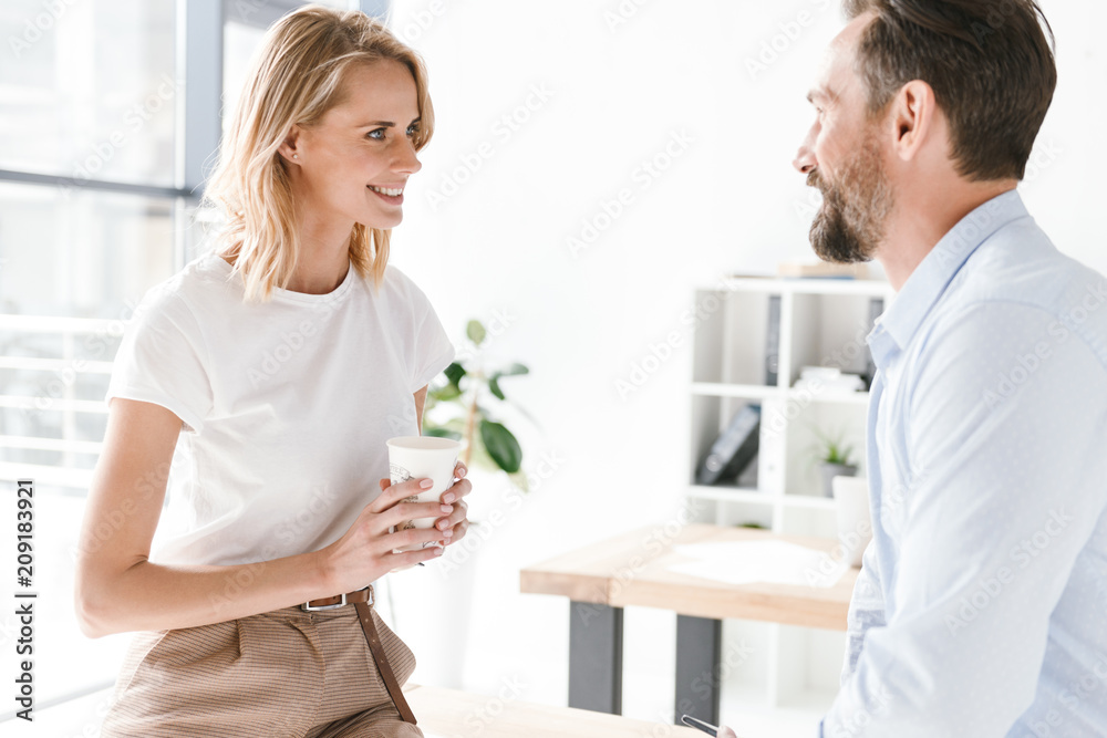 Fototapeta premium Couple of young colleagues talking