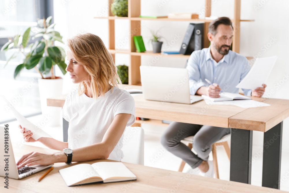 Concentrated woman manager working on laptop Concentrated woman manager working on laptop
