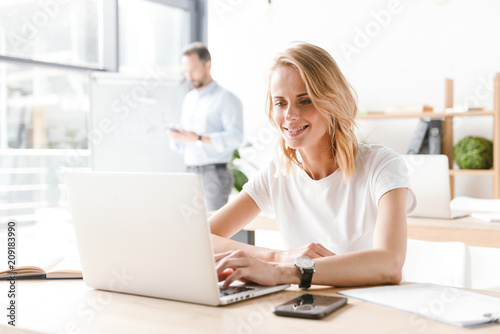 Attractive woman manager working on laptop computer