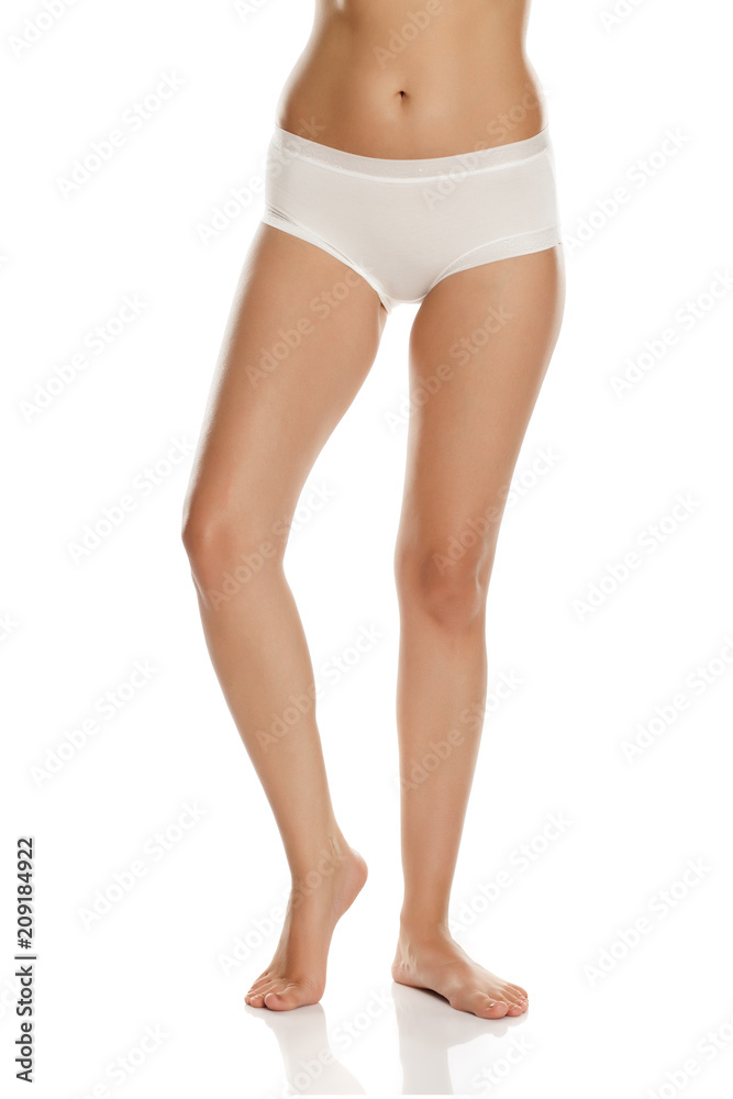 pretty feminine legs and white panties on white background
