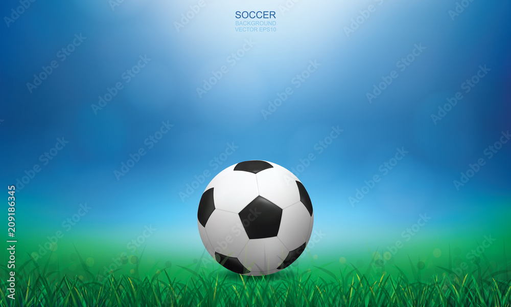 Soccer football ball on green grass of soccer field with light blurred bokeh background. Vector.