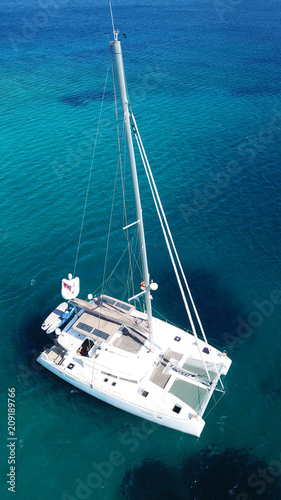 Aerial drone bird's eye view photo from luxury Catamaran docked at tropical deep waters  © aerial-drone