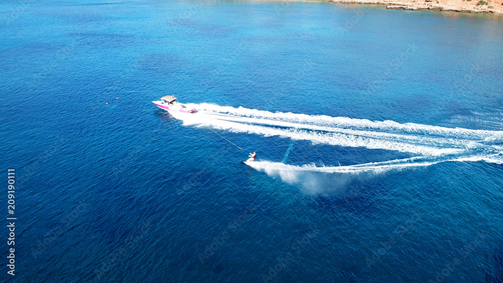Naklejka premium Aerial drone bird's eye view photo of man practicing water ski in tropical beach