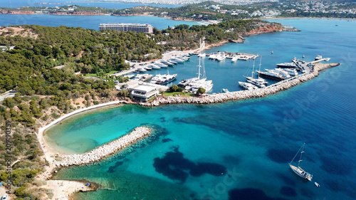 Aerial drone bird's eye photo of famous marina of Vouliagmeni with luxury yachts docked in south Athens riviera Peninsula with turquoise clear waters, Greece