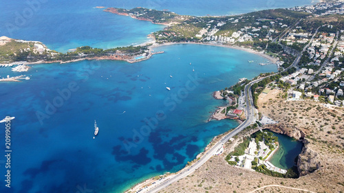 Fototapeta Naklejka Na Ścianę i Meble -  Aerial drone, bird's eye photo from iconic lake Vouliagmeni famous for healing abilities and Ateras Peninsula at the background, Athens riviera, Attica, Greece