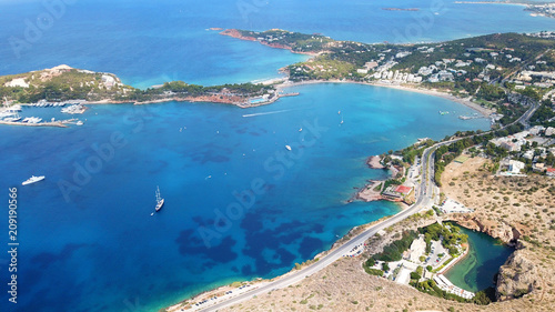 Aerial drone, bird's eye photo from iconic lake Vouliagmeni famous for healing abilities and Ateras Peninsula at the background, Athens riviera, Attica, Greece