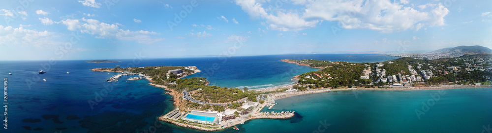 Aerial drone bird's eye view panoramic ultra wide 180 degrees photo of iconic Astir beach and Peninsula, Vouliagmeni, Athens riviera, Attica, Greece