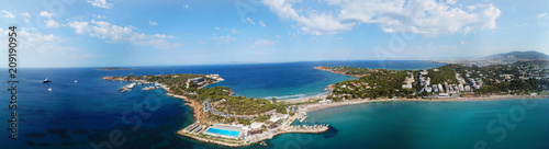 Aerial drone bird's eye view panoramic ultra wide 180 degrees photo of iconic Astir beach and Peninsula, Vouliagmeni, Athens riviera, Attica, Greece