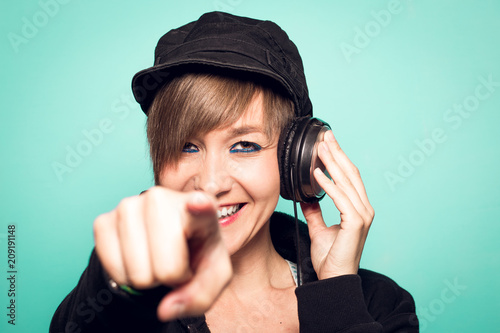 Sexy young girl with headphones looking at the camera and smiling.