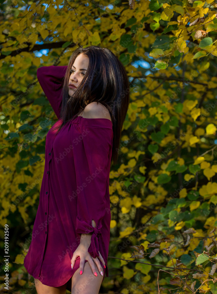 Beautiful woman posing sitting ground in autumn park Beautiful woman posing sitting ground in autumn park