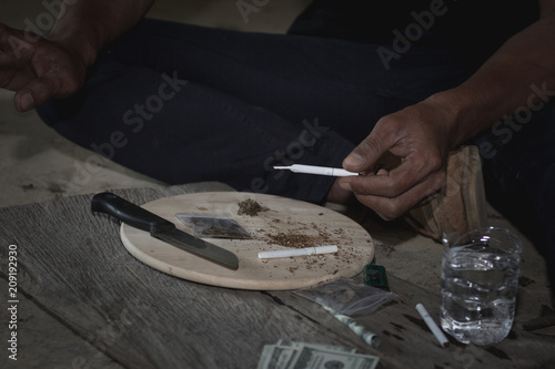 Men are preparing marijuana in order to smoke, The concept of crime and drug addiction. 26 June, International Day Against Drug Abuse and Illicit Trafficking