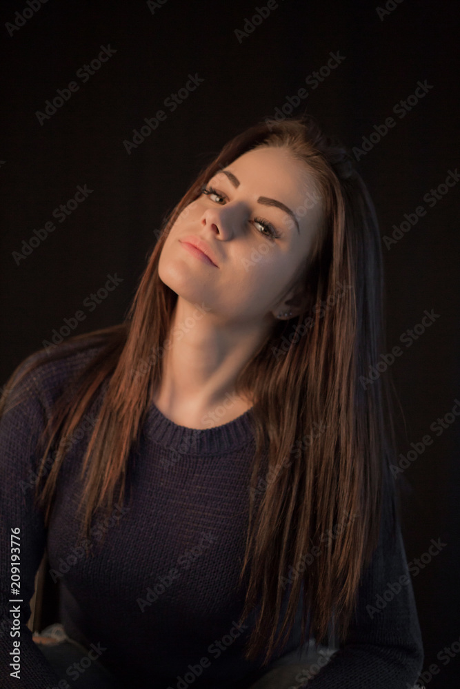 Studio portrait of young beautiful woman posing on black background Studio portrait of young beautiful woman posing on black background