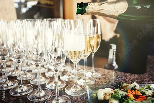 Waiter pouring champagne in the party photo