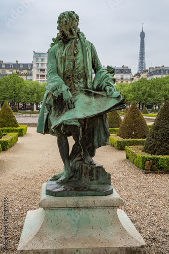 Statue of Jules Hardouin Mansart at Les Invalides gardens in Paris, France, with the Eiffel Tower in the background photo