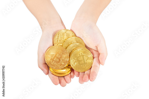 Children's hands holding golden Bitcoin