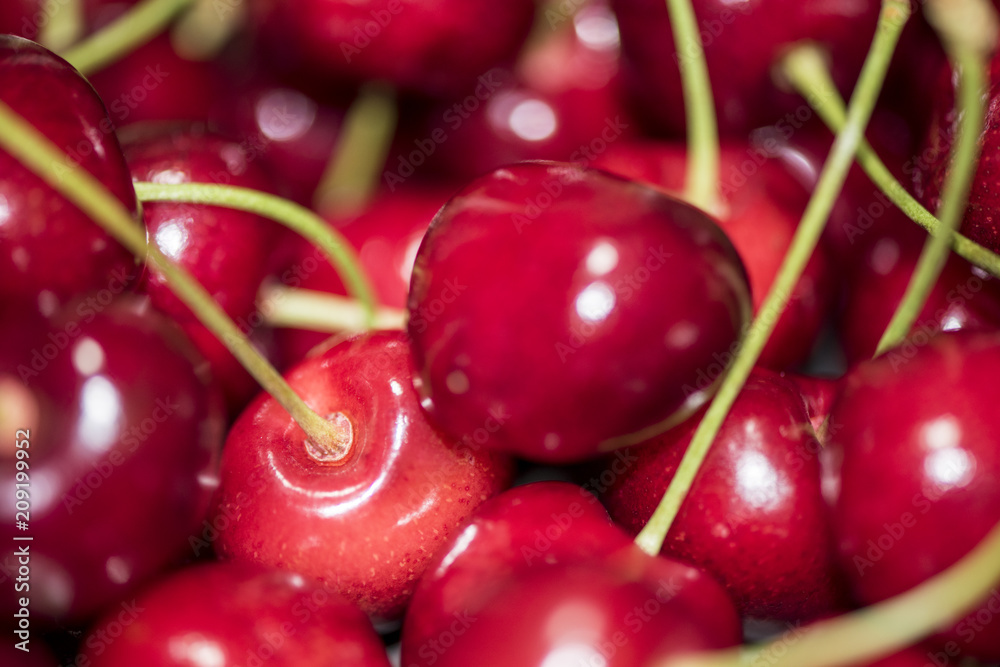 Dark, ripe and juicy cherries on a black plate Dark, ripe and juicy cherries on a black plate