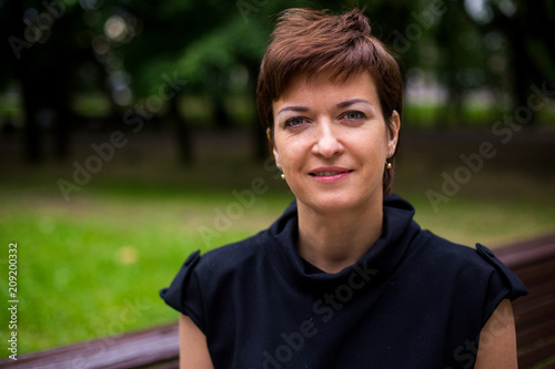 Portrait of beautiful aged woman in the park