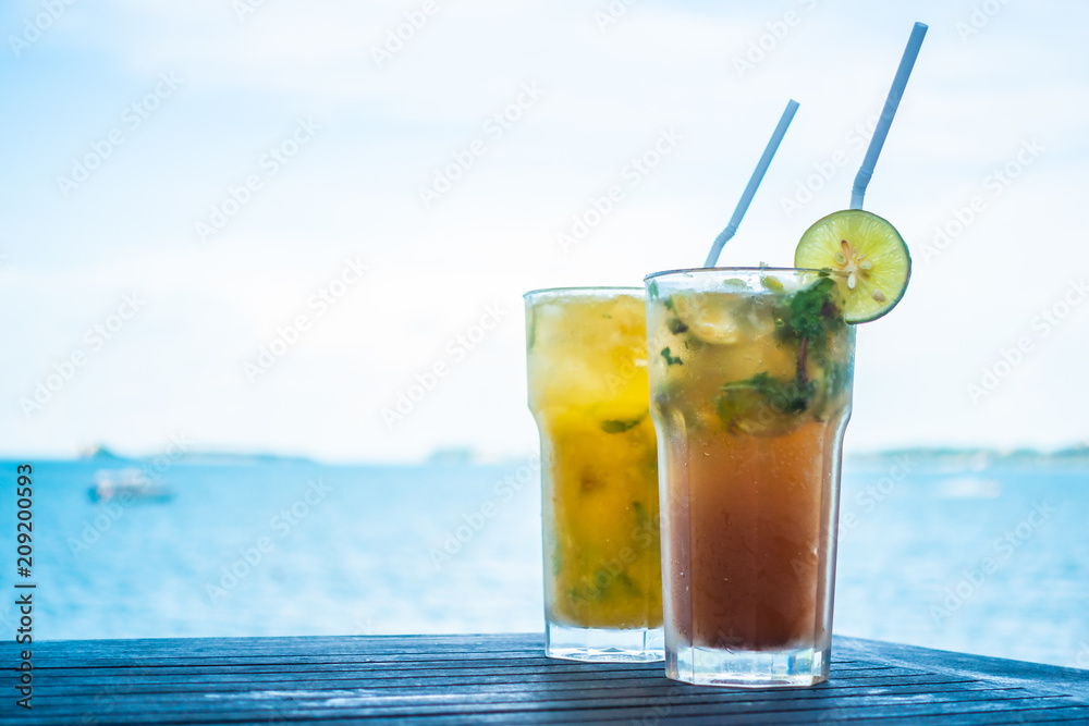Ice mojito drinking glass with tropical sea ocean Ice mojito drinking glass with tropical sea ocean