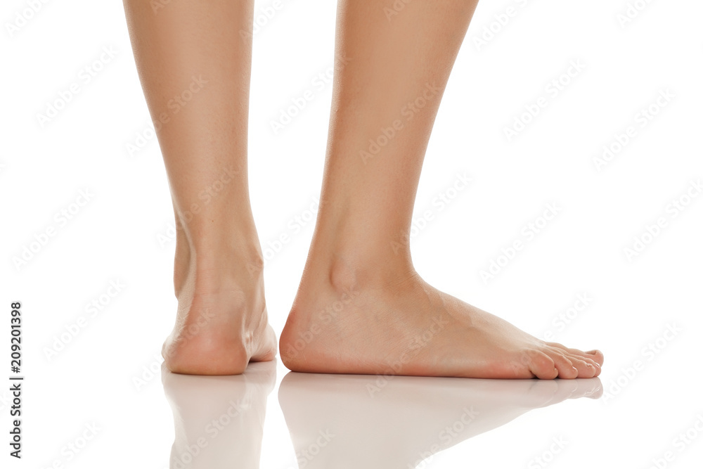 beautifully groomed bare feet on white background