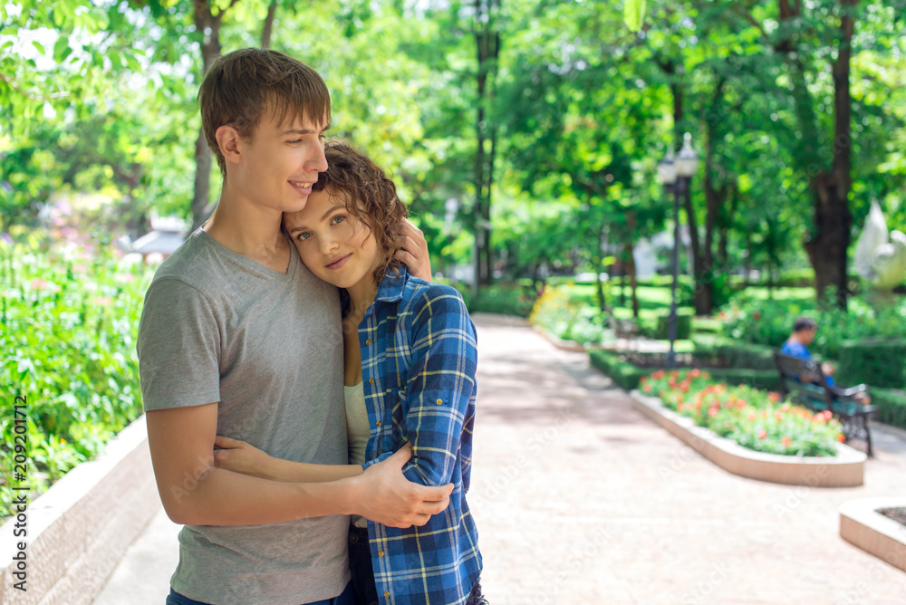 Young man huging a girl in the park. Young man huging a girl in the park.