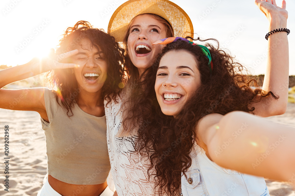 Three cheerful girls friends in summer clothes - obrazy, fototapety, plakaty 