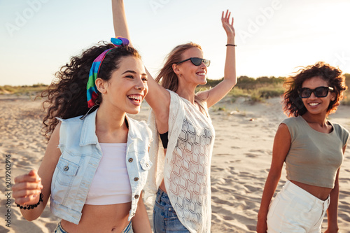 Sticker Three cheerful girls friends in summer clothes