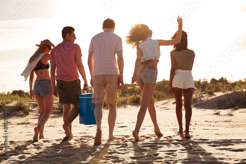 Group of happy young friends in summer clothes